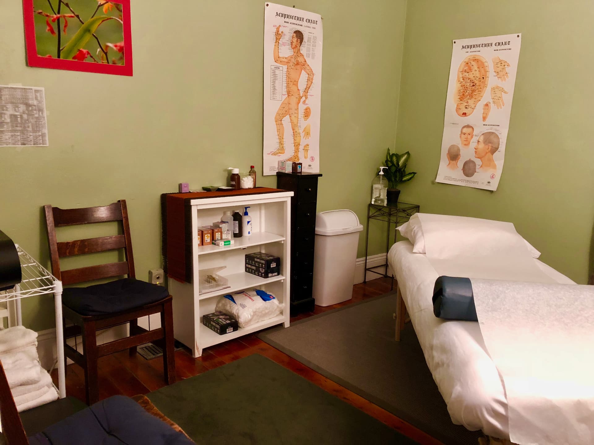 Treatment room with acupuncture body chart and massage table